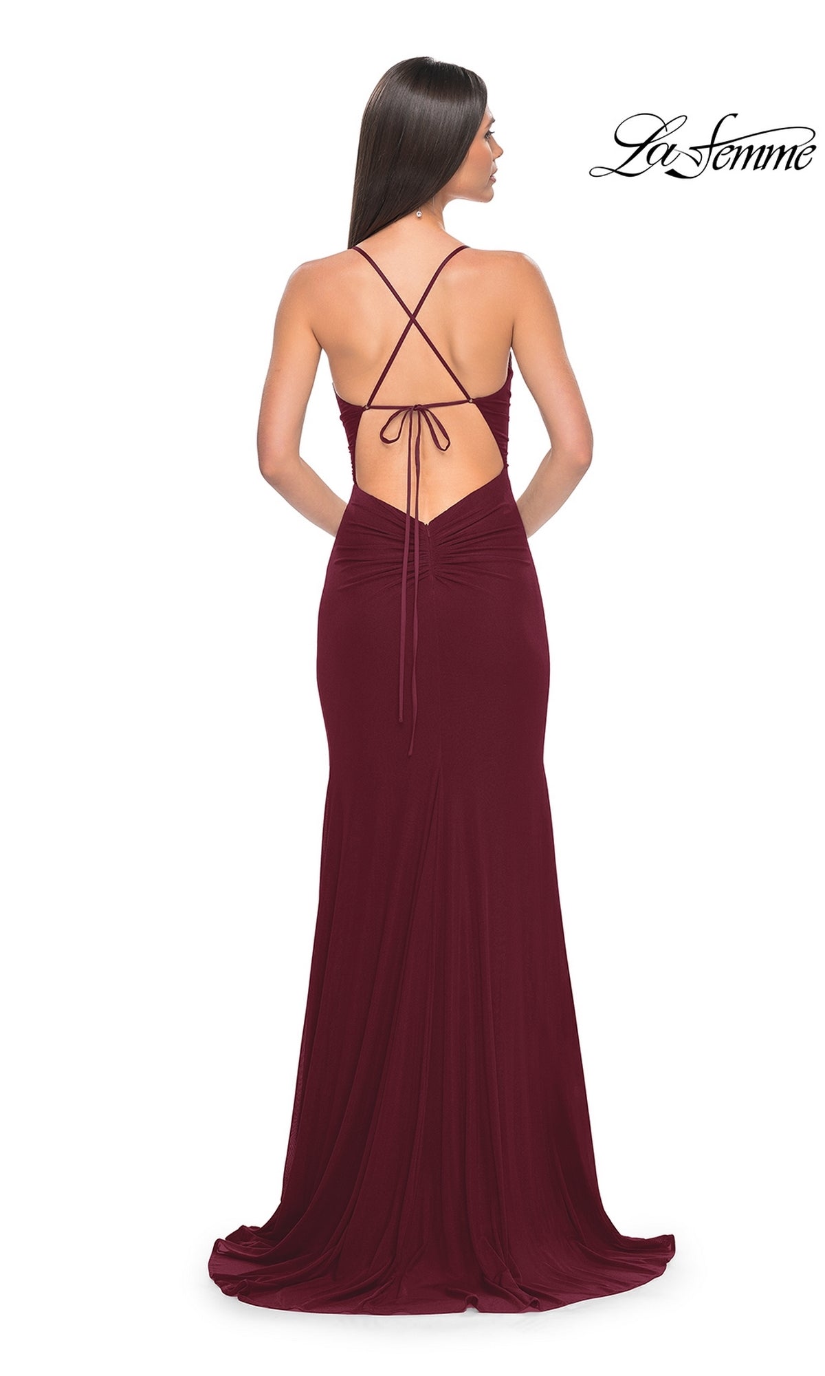 Woman in a floor-length, deep red La Femme Sheer-Waist Long Prom Dress 31151 with backless crisscross straps; La Femme logo displayed in the top right corner.